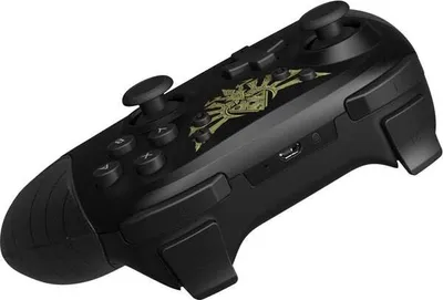 A black Nintendo Switch controller with a gold Legend of Zelda emblem on it, shown from a diagonal angle against a white background.