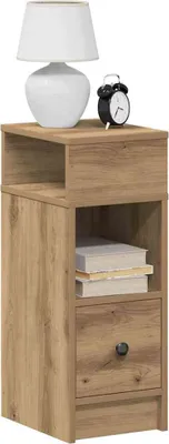 A wooden nightstand with a drawer and an open shelf, a white lamp, and a black alarm clock on top.