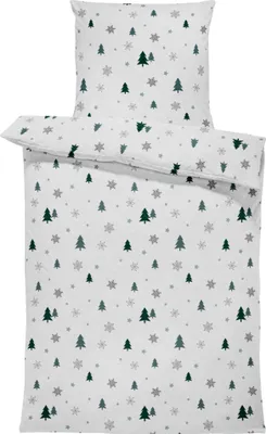 A folded duvet cover and pillowcase set with a winter-themed pattern of green Christmas trees and gray snowflakes on a white background.