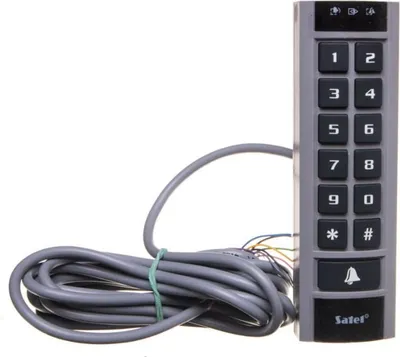 A close-up studio shot of a gray and black keypad with a coiled gray cable attached.