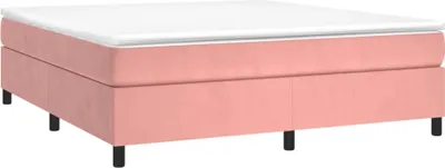 A pink upholstered bed frame with a white mattress.
