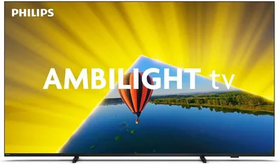 A Philips Ambilight TV displaying a vibrant image of a hot air balloon over a reflective body of water, with a bright yellow background radiating outwards.
