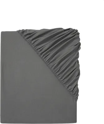 A close-up, top-down view of a dark gray fitted sheet, folded to show the elasticized corner.