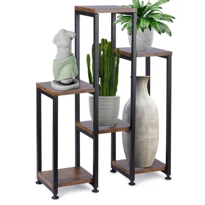 A multi-tiered plant stand with decorative items.