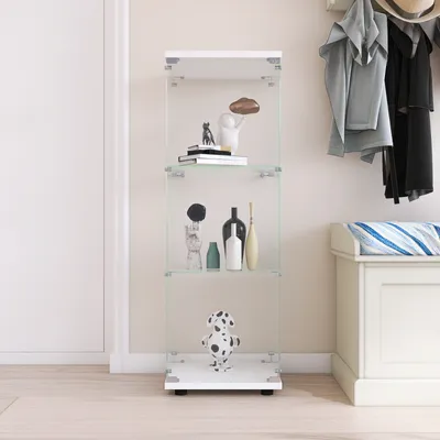 A white glass display cabinet with decorative items on its shelves, placed on a light wooden floor next to a white bench and a wall with hanging clothes.