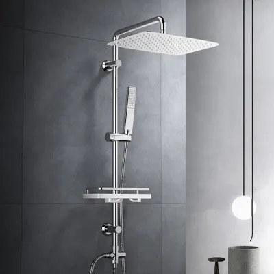 A modern shower system with a large square overhead shower head, a handheld shower head, and a storage shelf, mounted on a gray tiled wall.