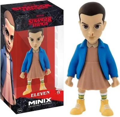 A collectible figurine of Eleven from Stranger Things, displayed in its packaging.
