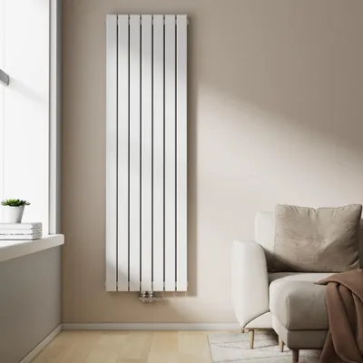 A modern living room with a white vertical designer radiator next to a window and a sofa.