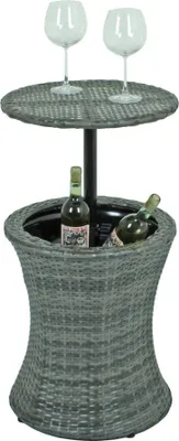 A table with a cooler and wine bottles, with two wine glasses on top.