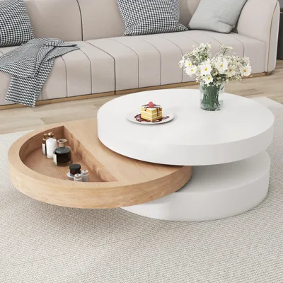 A modern living room scene featuring a rotating coffee table with storage, a sofa, and decorative items.