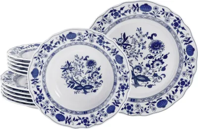 A stack of white plates with blue floral patterns.