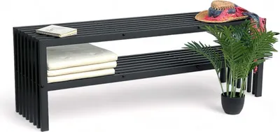 A black metal bench with two shelves, decorated with a straw hat, a scarf, and a potted plant.