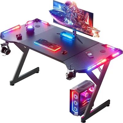 Produktbild von Gaming Schreibtisch 120 x 60 cm, Gaming Tisch mit LED, Stabiler PC Tisch mit Kohlefaserbeschichtung, Gamer Tisch mit Getränkehalter und Kopfhörerhaken, Schwarz