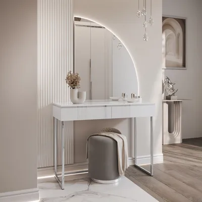 A modern vanity table with a large arched mirror in a well-lit room.