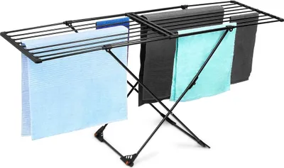 A black metal drying rack with several towels draped over it, set against a white background.