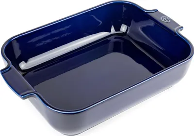 A blue ceramic baking dish is shown from a slightly elevated angle against a white background.