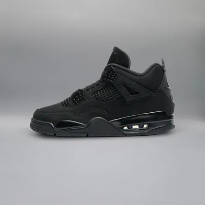 A side view of a black Nike Air Jordan 4 sneaker against a plain gray background.