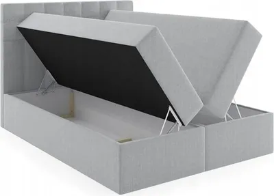 A light gray upholstered bed frame with the storage compartments open, revealing the interior space and lifting mechanisms.