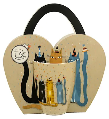 A heart-shaped gift box with a handle, containing a mug decorated with cats wearing party hats. The box and mug are adorned with confetti.