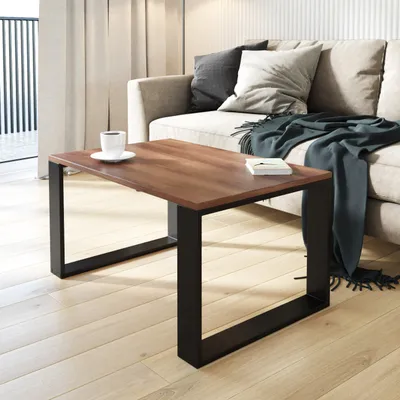 A coffee table with a cup of coffee and a book on it, placed in a living room setting with a couch and curtains.