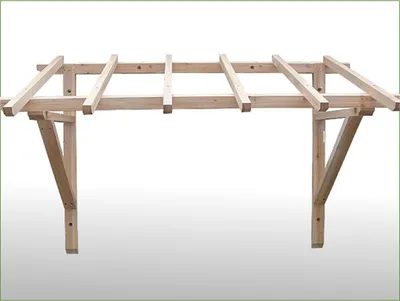 A wooden frame structure for a roof overhang, likely for a doorway or window.