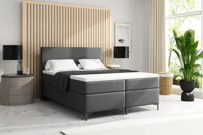 A bedroom scene with a bed, nightstand, and window.