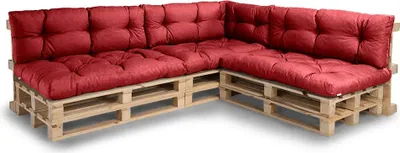 A sectional sofa made from wooden pallets with red cushions.
