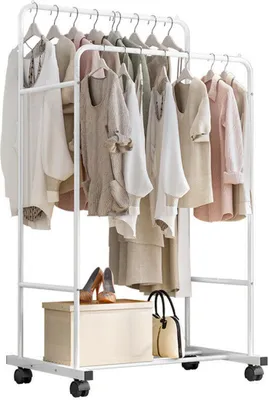 A white metal garment rack with two tiers of clothing and a shelf at the bottom.