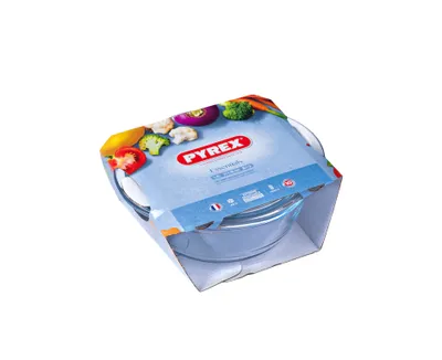 A Pyrex glass bowl with a lid, presented in its retail packaging.