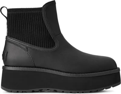 A black UGG boot with a platform sole and knitted cuff is shown against a white background.