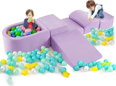 Two children playing with a purple foam climbing block set and colorful balls.