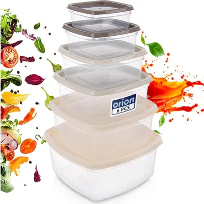 A stack of clear plastic food containers with lids, with graphics of vegetables and juice splashes around them.