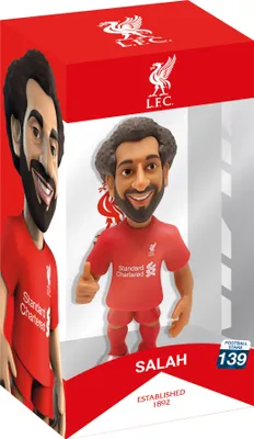 A cartoon-like figurine of a soccer player, Mohamed Salah, in his Liverpool FC uniform, displayed in its retail packaging.