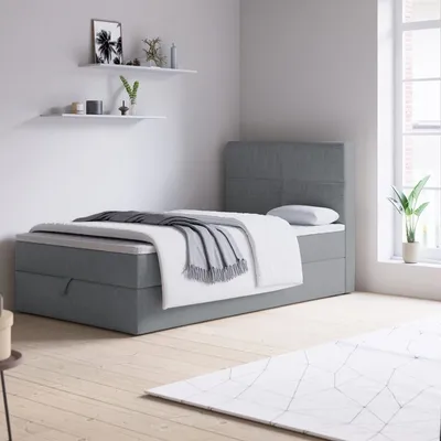 A bedroom scene with a bed, shelves, and a window.