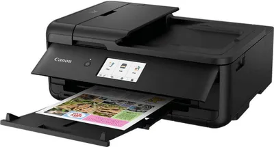 A black Canon PIXMA TS9550 printer is shown with a printed document emerging from the output tray.