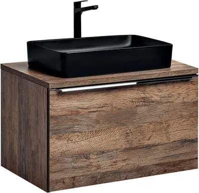 A black vessel sink and faucet are mounted on a vintage oak-look vanity.
