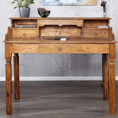 A wooden secretary desk is shown against a gray textured wall.