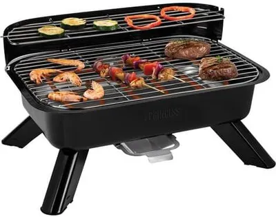 A black electric barbecue grill with food on the grates, set against a white background.