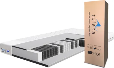 A cutaway view of a mattress next to its packaging.
