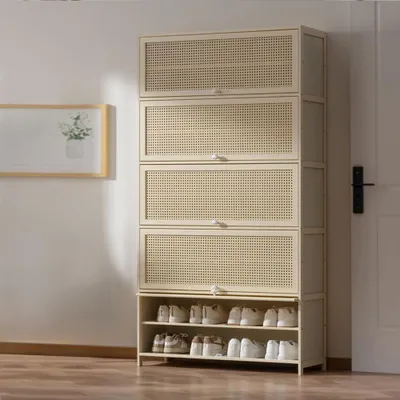 A tall, beige shoe storage cabinet with multiple shelves and doors, displaying shoes on the bottom two shelves.