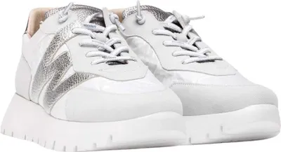 A pair of white and silver women's sports shoes with platform soles, shown from a slightly elevated side angle against a white background.
