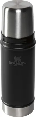 A black and silver Stanley thermos bottle against a white background.
