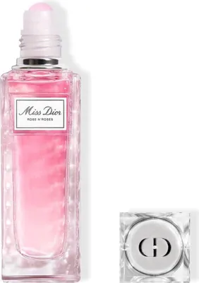 A product shot of a Dior Miss Dior Rose N'Roses Edt Roller-Pearl perfume bottle and its cap.