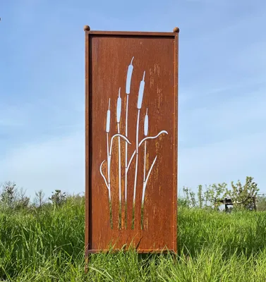A metal garden decoration with a cattail motif stands in a grassy field under a clear blue sky.