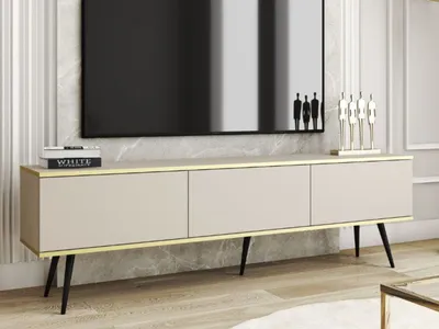 A modern TV stand with a minimalist design, featuring three cabinets and sleek metal legs, placed in a well-lit living room setting.