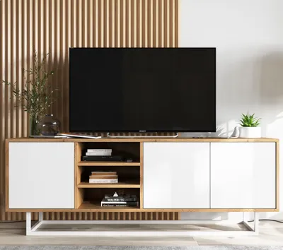 A modern TV cabinet with a television on top, set against a slatted wooden wall.