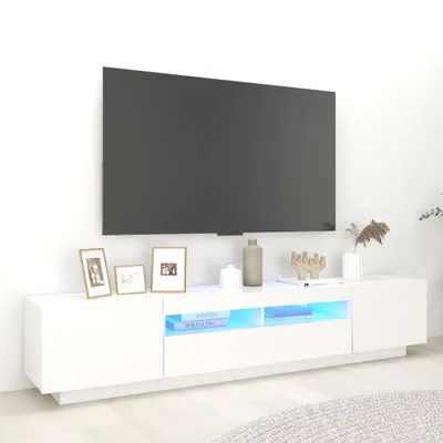 A white TV stand with LED lighting is shown in a room with a large TV mounted above it.