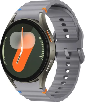 A close-up studio shot of a smartwatch with a gray band and a dark face displaying an orange and white graphic.