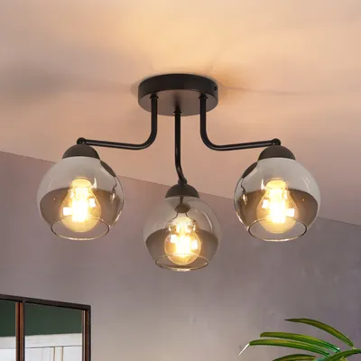 A black ceiling light fixture with three glass globes is shown against a light gray and white background.