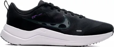 A black Nike DOWNSHIFTER 12 running shoe with a white sole is shown against a white background.